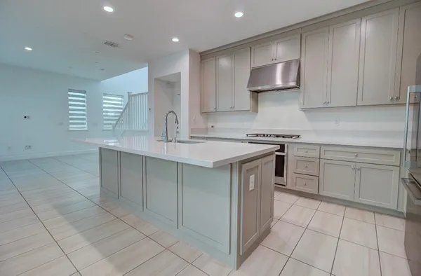 a kitchen with a sink cabinets and appliances