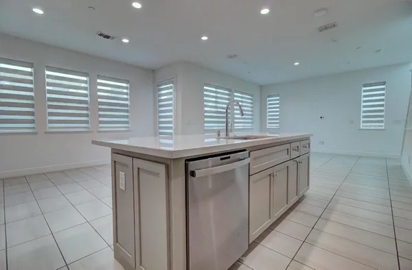 a kitchen with stainless steel appliances granite countertop a sink a granite counter tops and a window