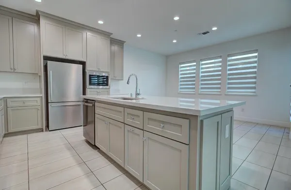 a kitchen with a refrigerator and a sink