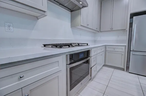 a kitchen with cabinets appliances and a counter space