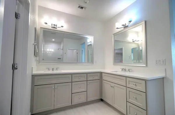 a bathroom with a sink double vanity and a mirror