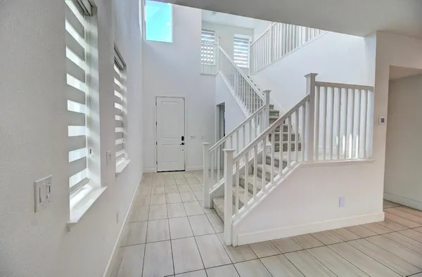 a view of entryway with stairs and wooden floor