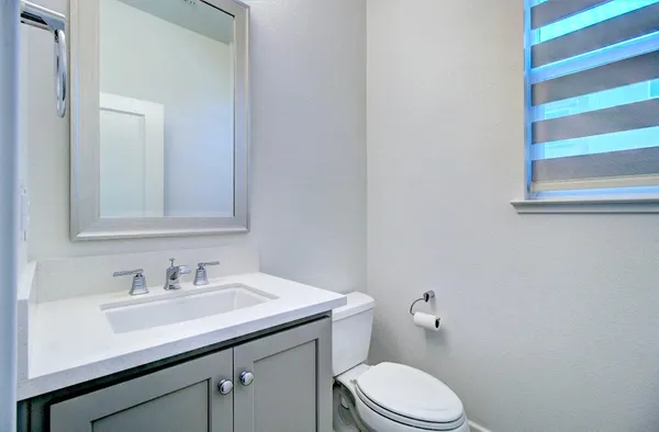 a bathroom with a sink toilet and vanity