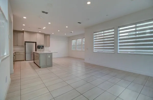 a kitchen with stainless steel appliances a refrigerator and a stove top oven