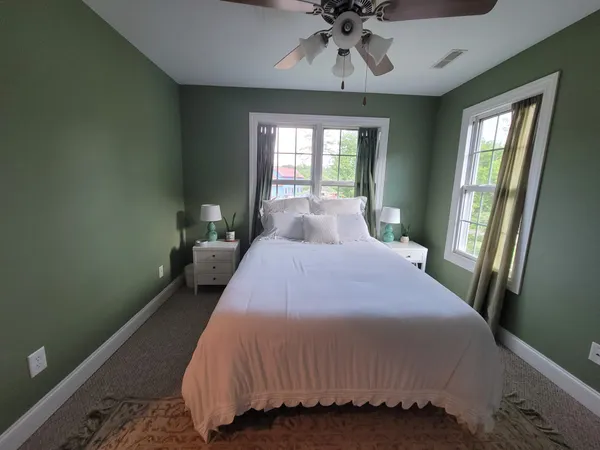 a bedroom with a bed and window