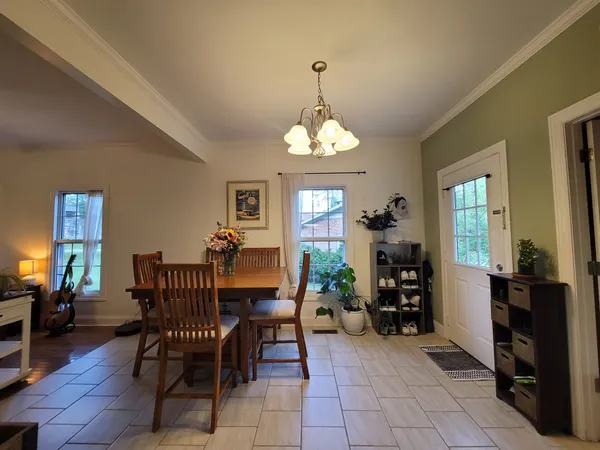 a dining room with furniture and window