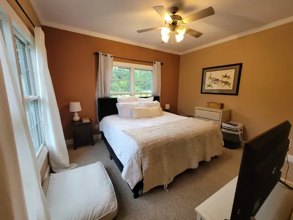 a bedroom with a bed and a window