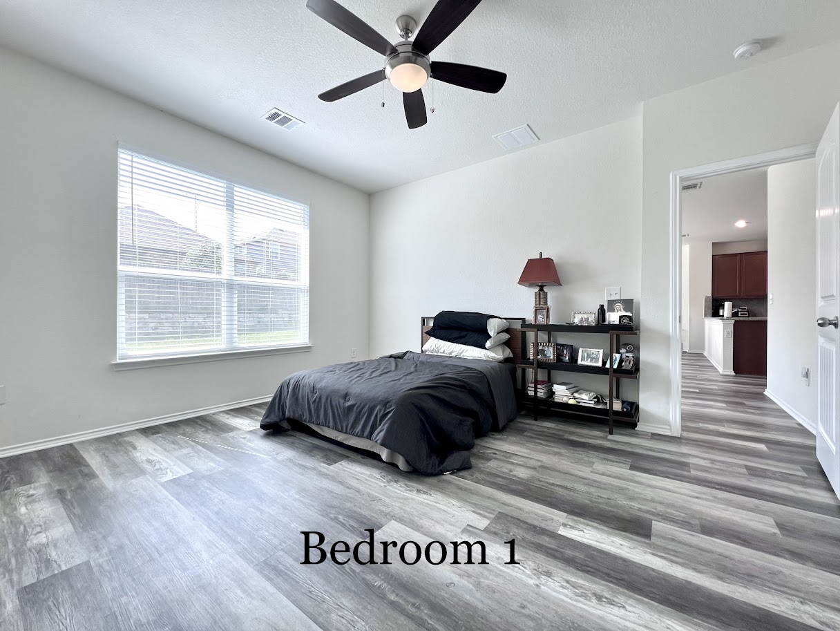 7900 Crystalbrook West Austin, TX 78724 - Photo 23 of 27 a spacious bedroom with a bed a dresser and a window