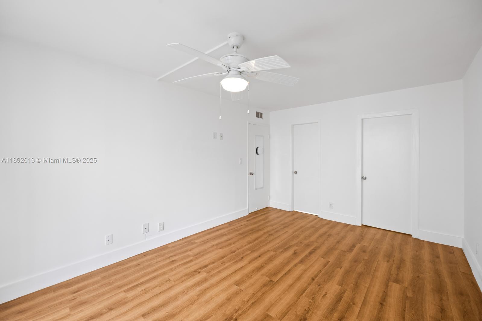1440 Brickell Bay Drive, Unit 307 Miami, FL 33131 - Photo 14 of 28 a view of empty room with wooden floor