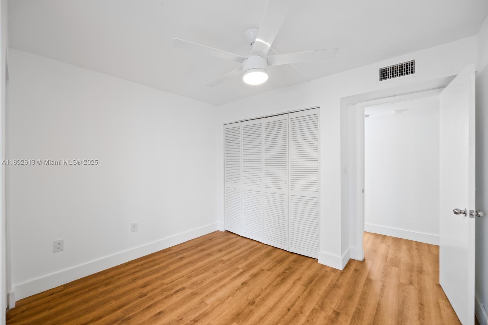 1440 Brickell Bay Drive, Unit 307 Miami, FL 33131 - Photo 19 of 28 wooden floor in an empty room