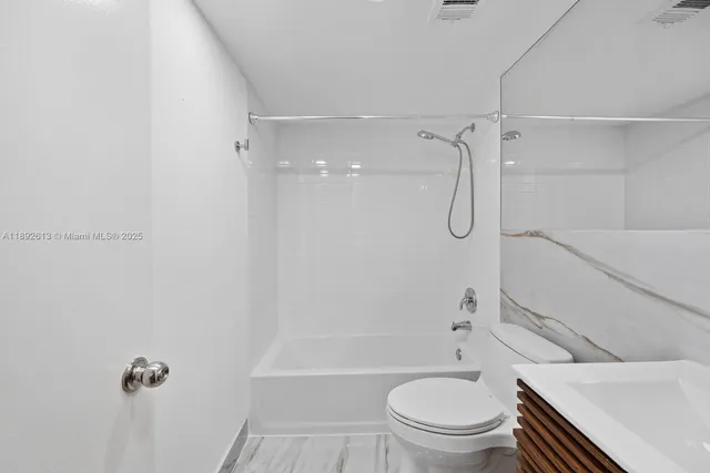 a bathroom with a sink toilet tub and shower