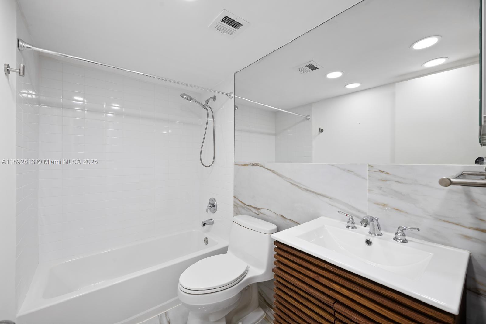 1440 Brickell Bay Drive, Unit 307 Miami, FL 33131 - Photo 21 of 28 a bathroom with a sink toilet tub and shower