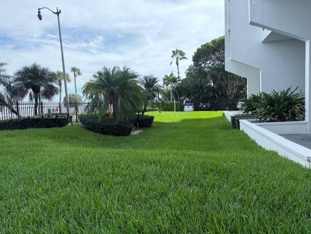 1440 Brickell Bay Drive, Unit 307 Miami, FL 33131 - Photo 25 of 28 a view of a garden with a tree in the background