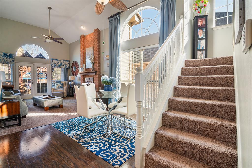a living room with furniture a chandelier and a dining table