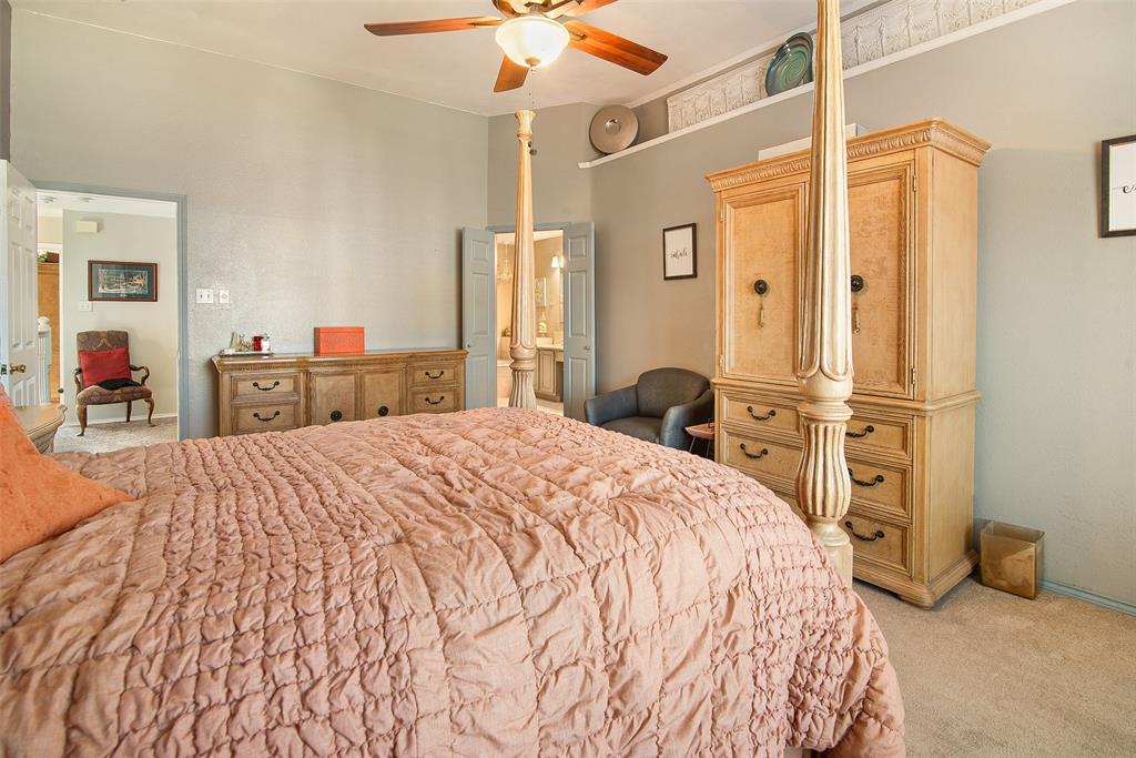 409 Red River Trail Irving, TX 75063 - Photo 16 of 31 a bedroom with a bed and a chandelier