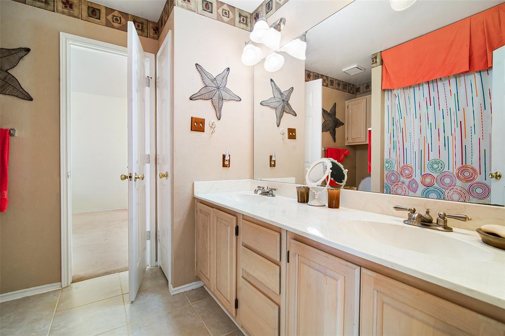 409 Red River Trail Irving, TX 75063 - Photo 23 of 31 a bathroom with a sink vanity granite shower and a mirror