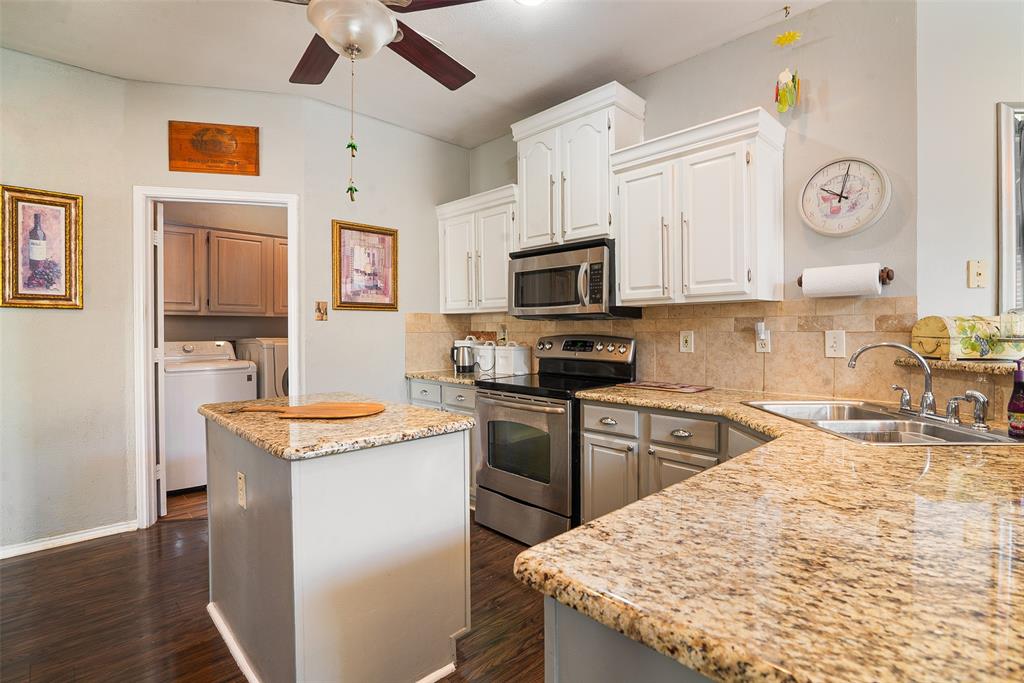 409 Red River Trail Irving, TX 75063 - Photo 8 of 31 a kitchen with stainless steel appliances granite countertop a sink stove refrigerator and microwave
