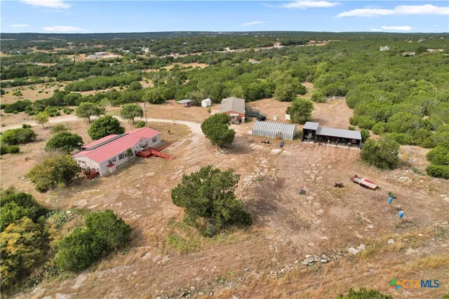 an aerial view of residential houses with outdoor space