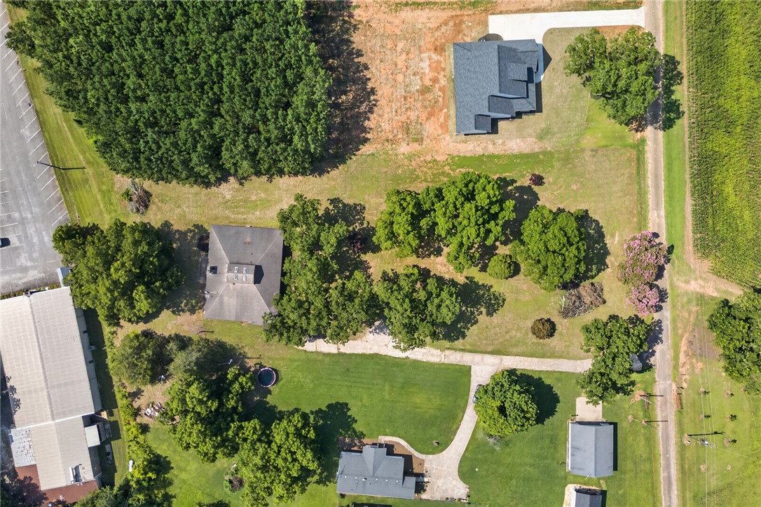 1412 Simpson Road Pendleton, SC 29670 - Photo 40 of 48 An aerial perspective showcases the spacious grounds with mature trees and ample green space, presenting an idyllic canvas for country living.