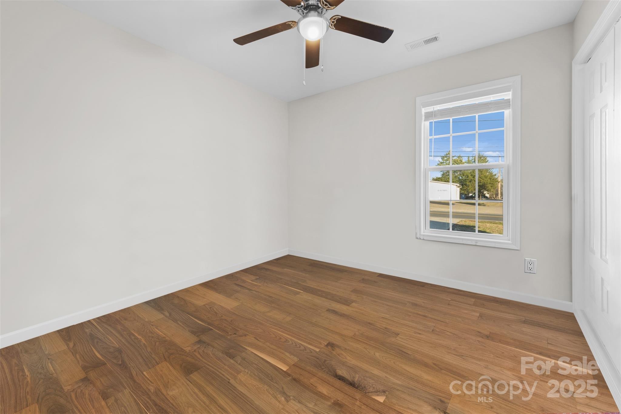 177 Duke Street Granite Falls, NC 28630 - Photo 16 of 23 a view of an empty room with wooden floor and a window