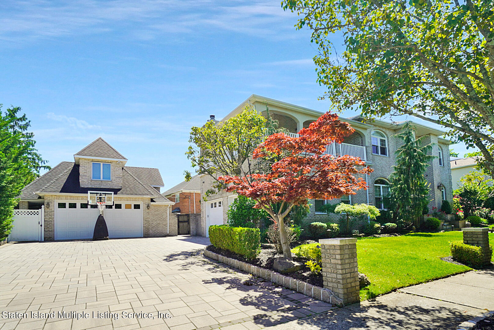 312 Shore Road Staten Island, NY 10307 - Photo 3 of 73 a front view of a house with a yard and a garden