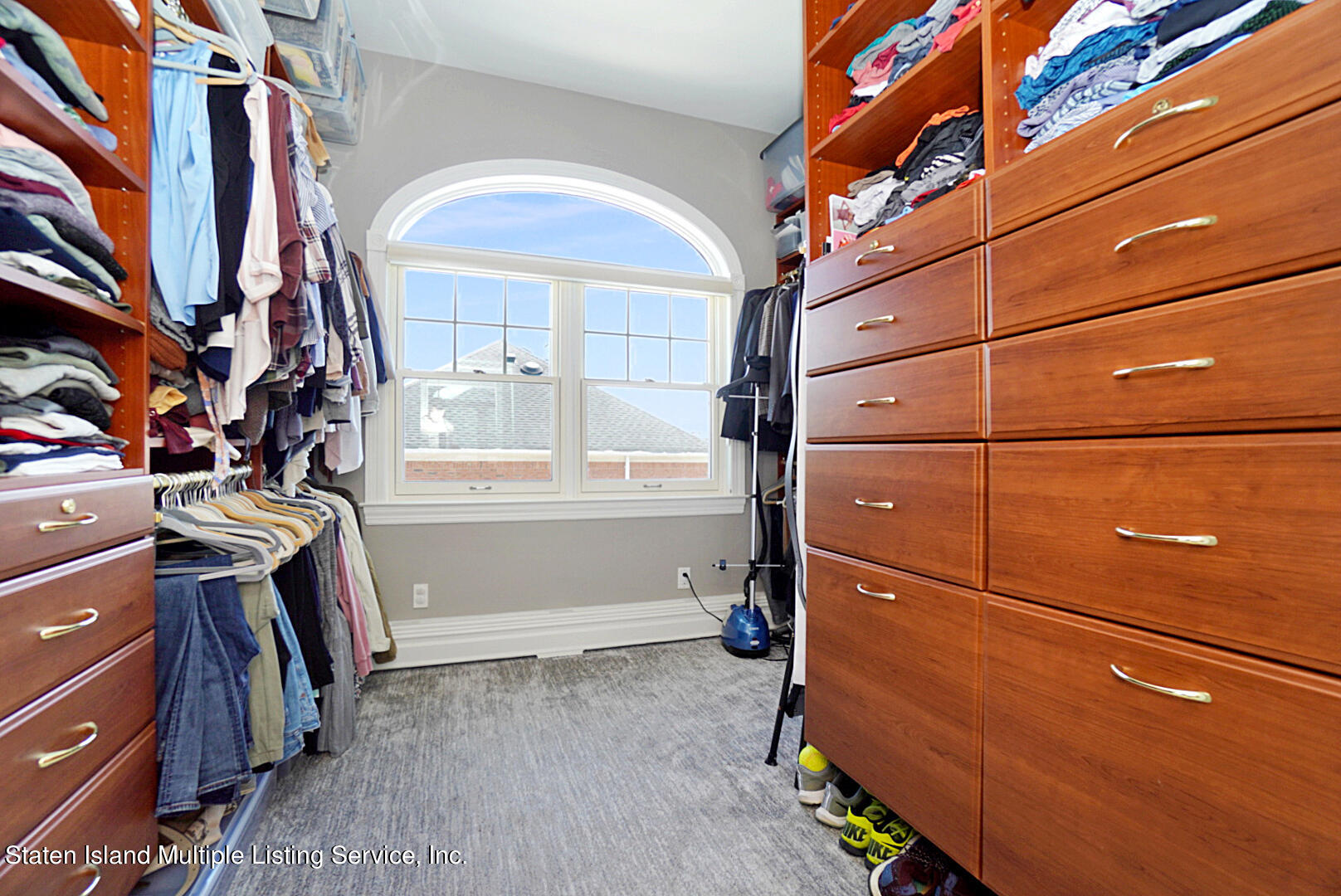 312 Shore Road Staten Island, NY 10307 - Photo 41 of 73 a view of walk in closet with clothes and shoes