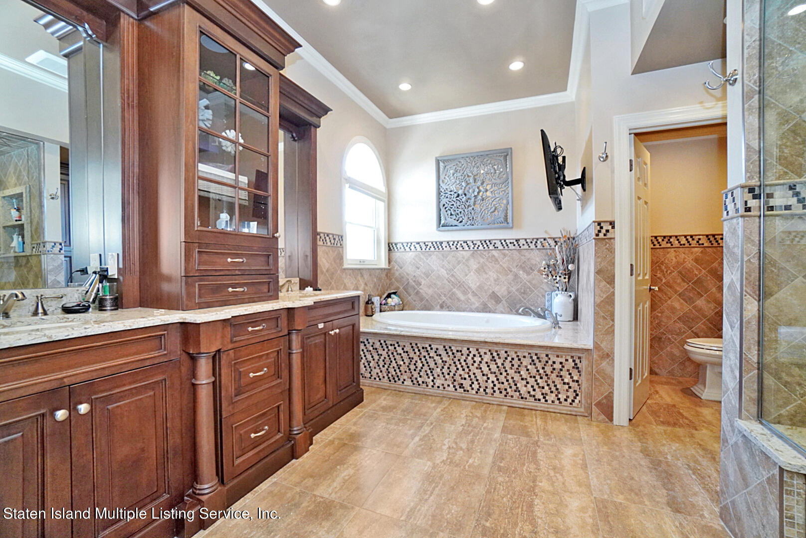 312 Shore Road Staten Island, NY 10307 - Photo 42 of 73 a en suite bathroom with a sink a mirror and a bathtub