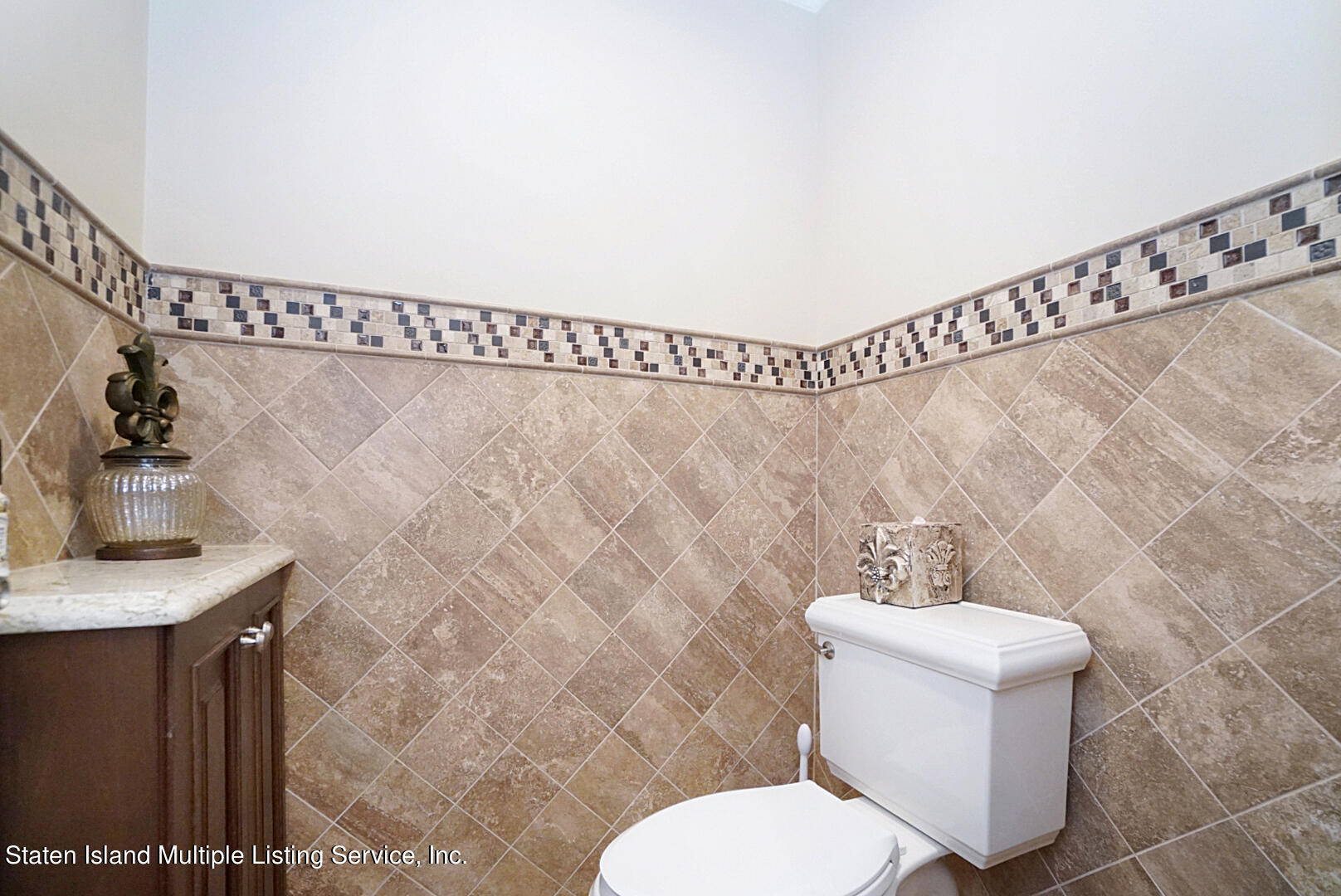 312 Shore Road Staten Island, NY 10307 - Photo 47 of 73 a white toilet sitting next to a bathroom sink