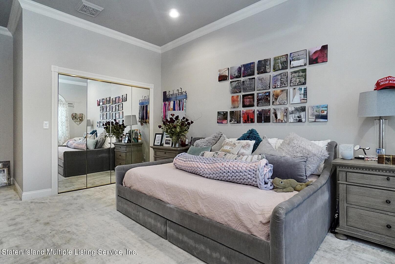 312 Shore Road Staten Island, NY 10307 - Photo 49 of 73 a bedroom with bed and a book shelf