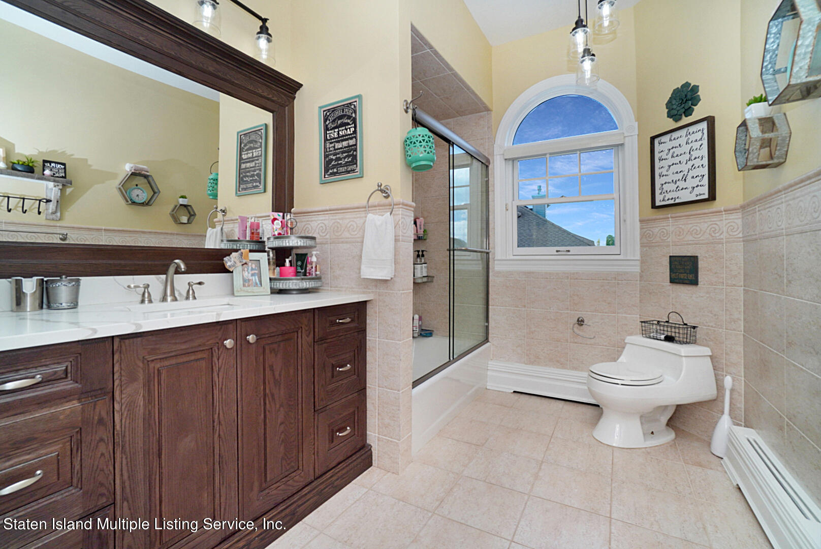 312 Shore Road Staten Island, NY 10307 - Photo 54 of 73 a spacious bathroom with a toilet sink and mirror