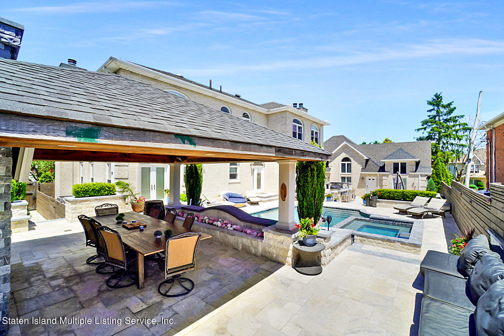 312 Shore Road Staten Island, NY 10307 - Photo 67 of 73 a view of a patio with dining table and chairs potted plants with wooden floor and fence