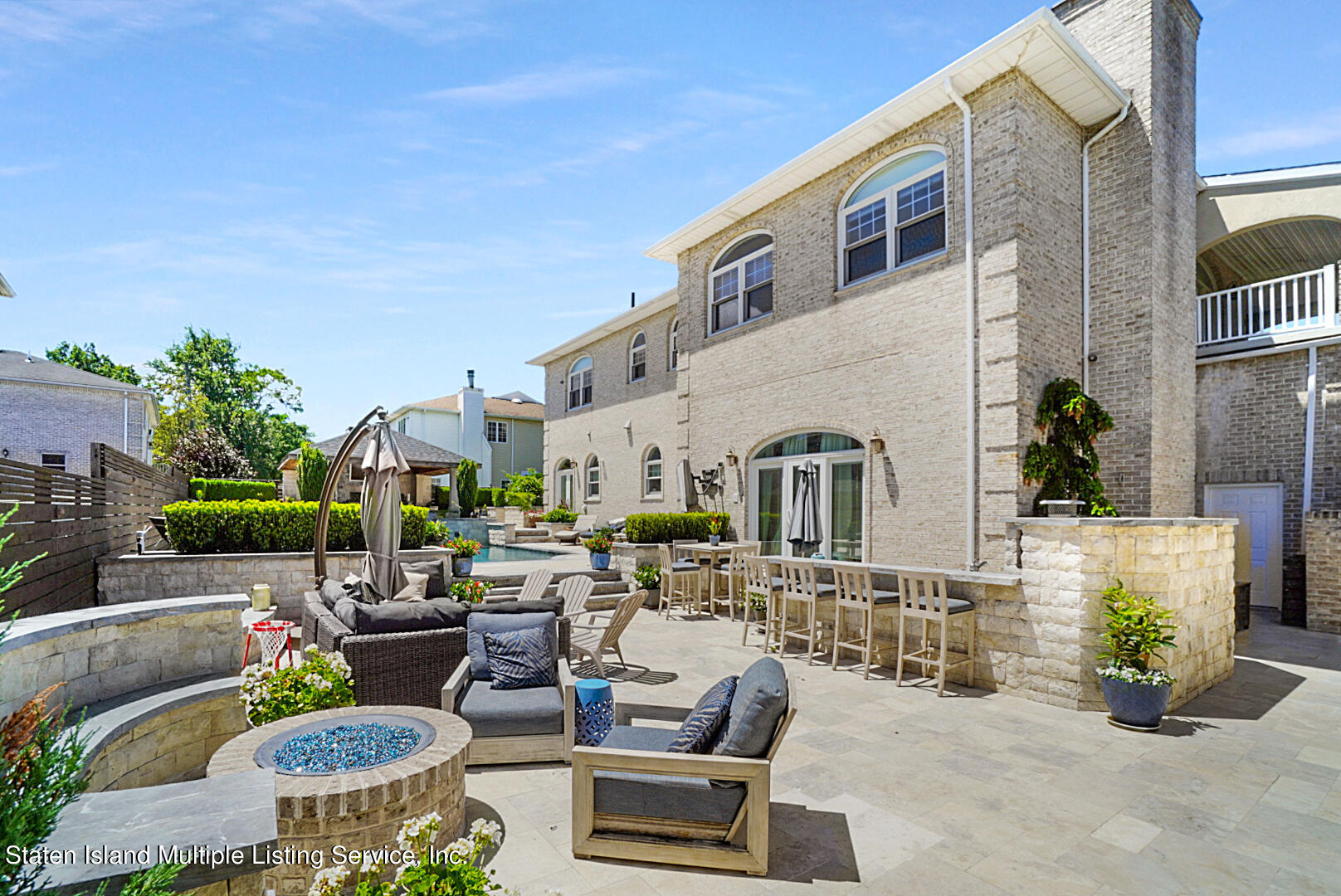 312 Shore Road Staten Island, NY 10307 - Photo 68 of 73 a view of a patio with couches table and chairs potted plants and palm tree