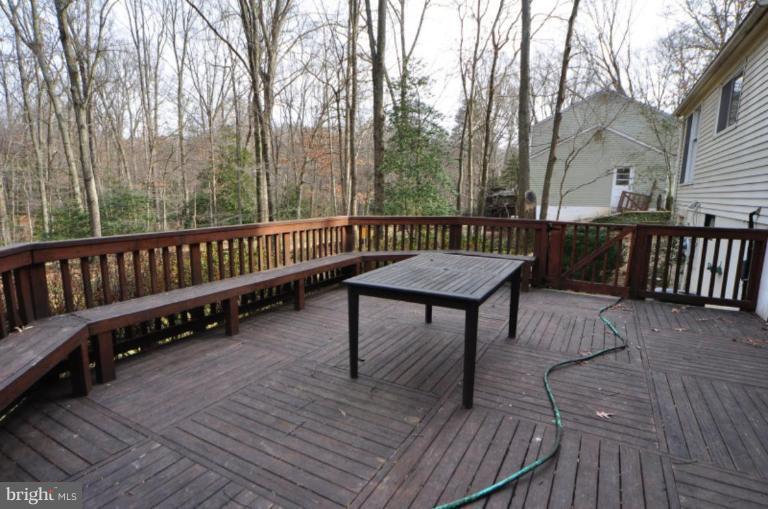 2509 Foxcroft Way Reston, VA 20191 - Photo 16 of 22 a view of a roof deck with wooden floor and fence