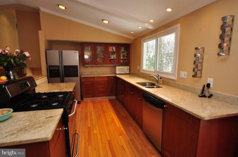 2509 Foxcroft Way Reston, VA 20191 - Photo 17 of 22 a kitchen with stainless steel appliances granite countertop a sink stove and cabinets