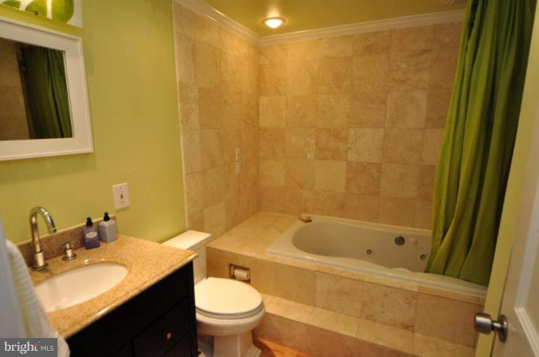 2509 Foxcroft Way Reston, VA 20191 - Photo 3 of 22 a bathroom with a sink and a mirror