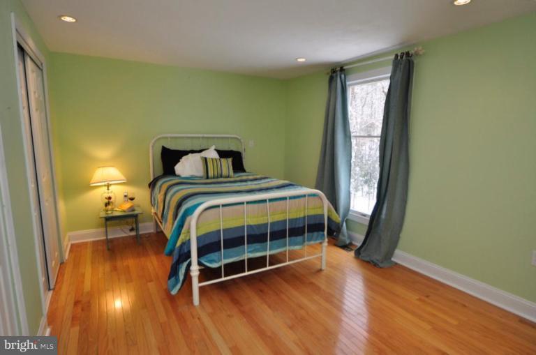 2509 Foxcroft Way Reston, VA 20191 - Photo 22 of 22 a bedroom with a bed and wooden floor