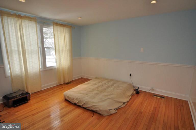 2509 Foxcroft Way Reston, VA 20191 - Photo 4 of 22 an empty room with wooden floor and windows