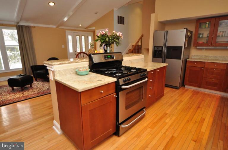 2509 Foxcroft Way Reston, VA 20191 - Photo 8 of 22 a kitchen with granite countertop a stove and cabinets