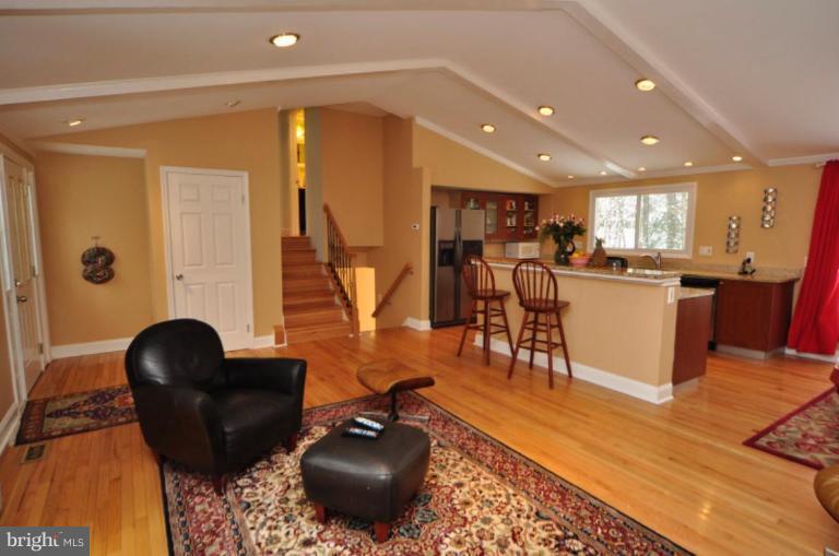 2509 Foxcroft Way Reston, VA 20191 - Photo 9 of 22 a living room with furniture a wooden floor and a large window