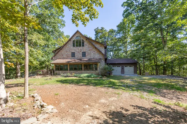 a view of backyard with a table and chairs and potted plants