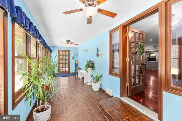 a dining room with wooden floor and chandelier