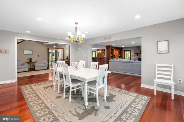 a bed sitting in a spacious bedroom next to a window