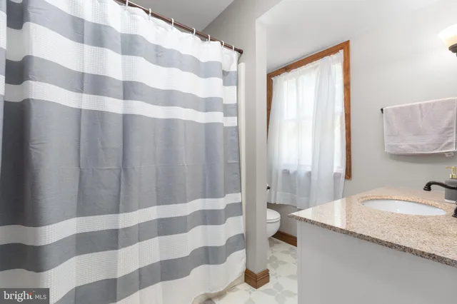 a bedroom with two beds and a large window