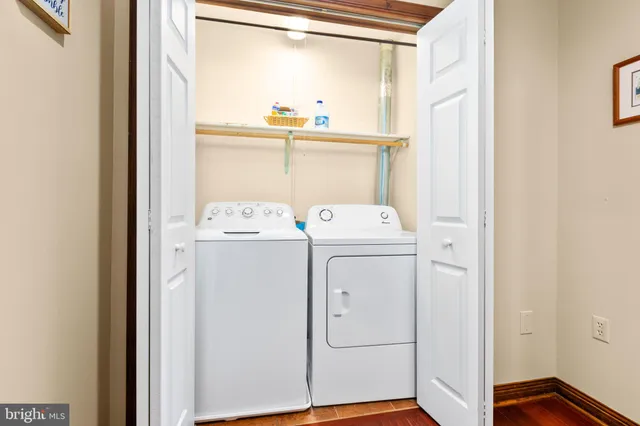 a bedroom with a large bed and wooden floor