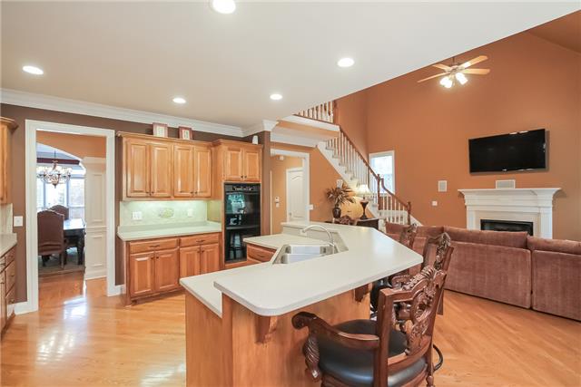 1099 Sunset Road Brentwood, TN 37027 - Photo 7 of 20 Open kitchen with oak cabinetry, Corian counters, gas cooktop and double ovens