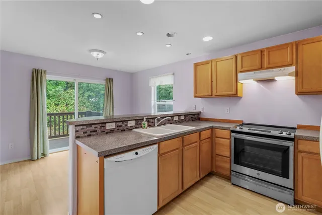 a kitchen with a sink stove and cabinets