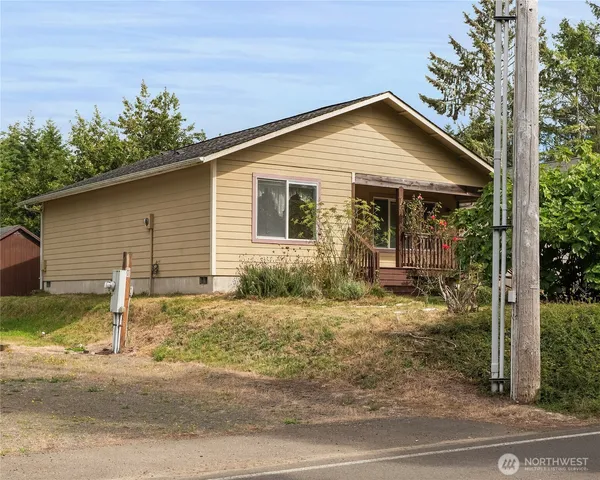 a front view of house with yard and trees around