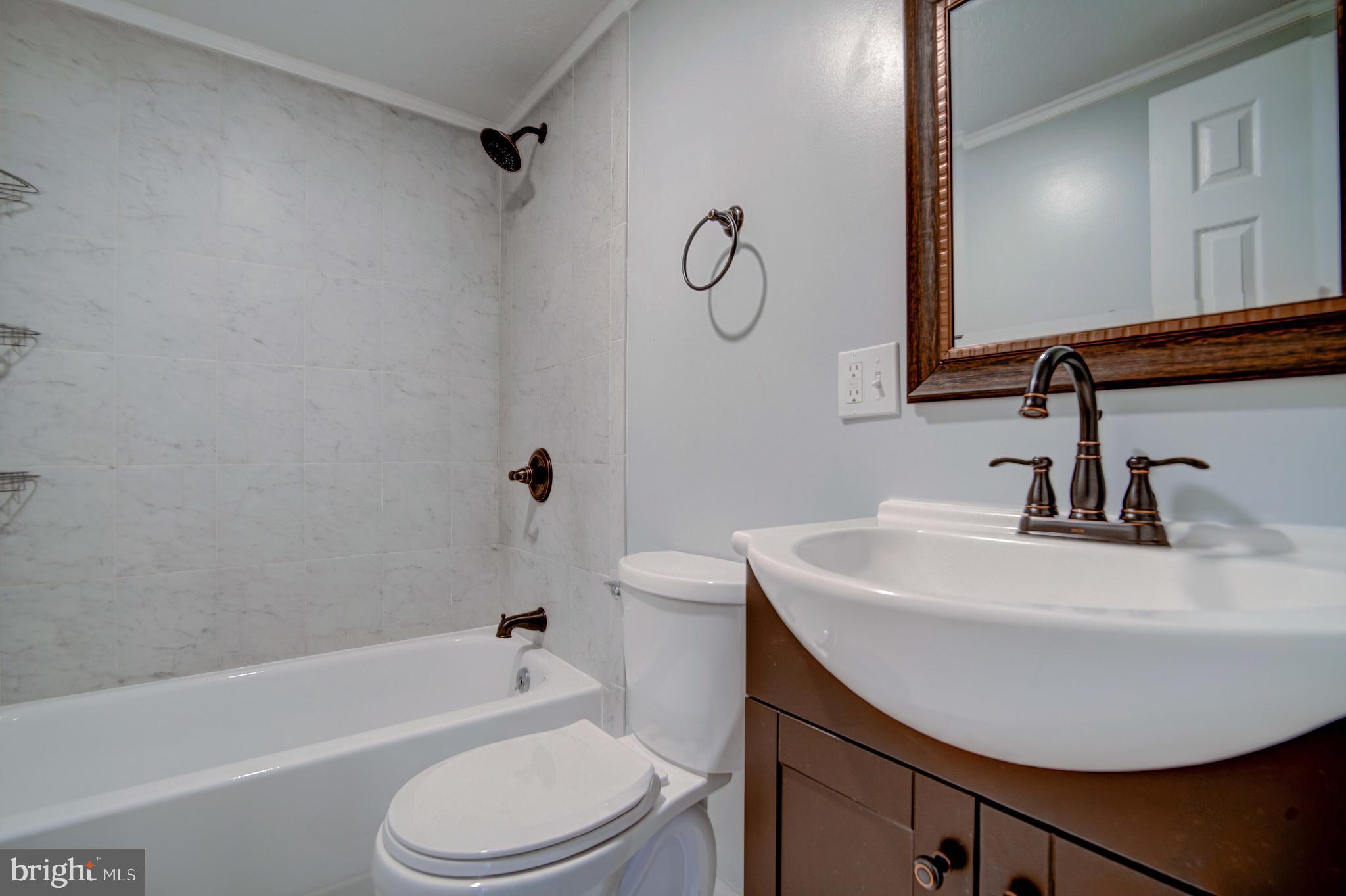245 Newtown Road Solomons, MD 20688 - Photo 19 of 26 a bathroom with a sink toilet and a bathtub
