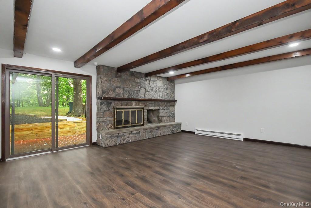 18 Hillside View Road Mahopac, NY 10541 - Photo 17 of 42 an empty room with wooden floor fireplace and windows