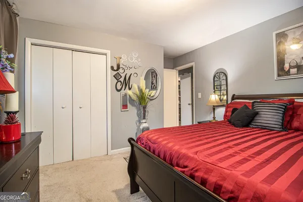 a bedroom with a bed and a closet